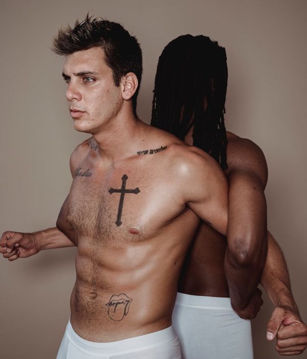 Focused man performing a bodyweight strength exercise in a bright, modern studio.